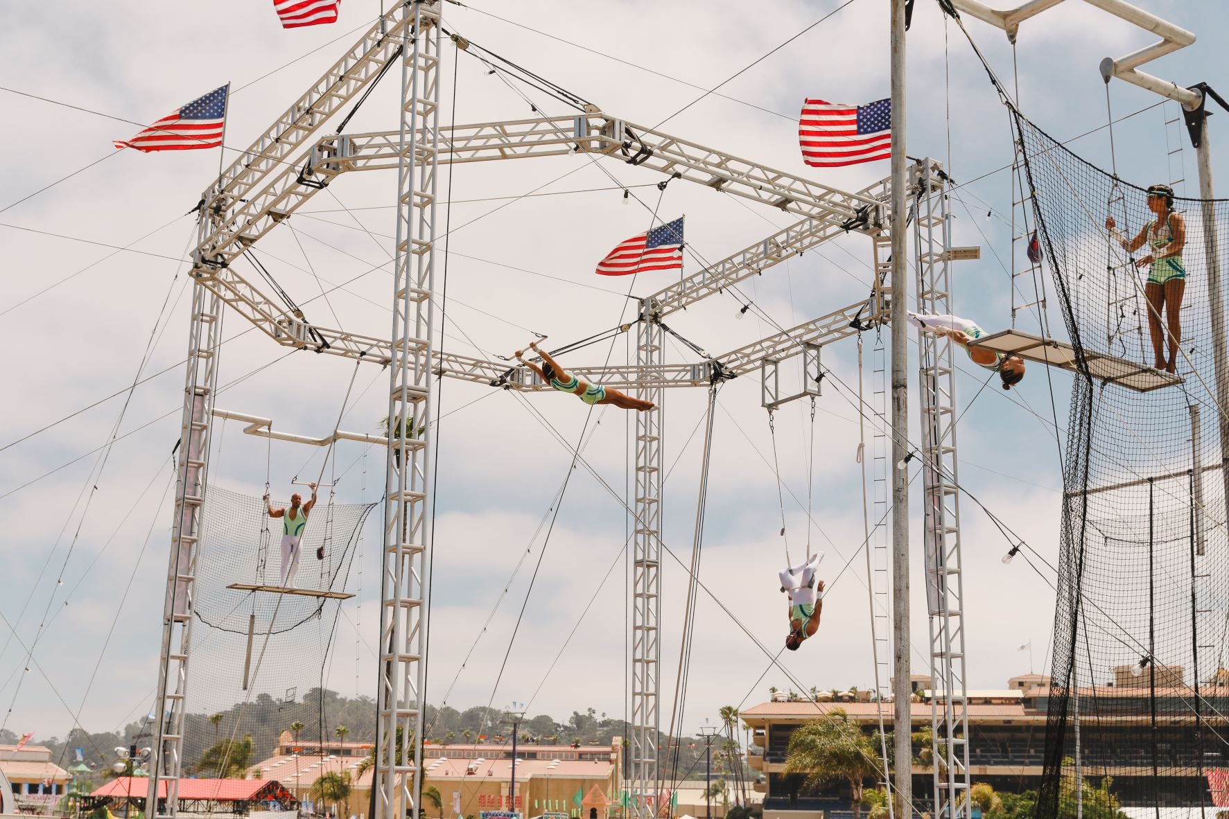 The Flying Royals performing on a large outdoor flying-trapeze rig