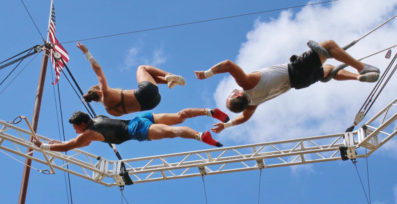 Four Flying Royals performers in an outdoor aerial sequence